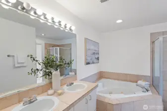 The 5-piece primary en-suite bathroom features a large jetted soaking tub, separate shower and double vanity.