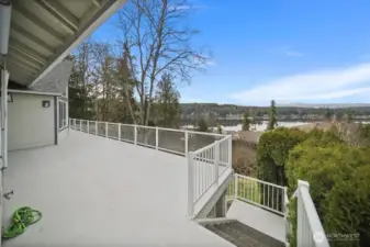 Main floor deck and aggregate stairs to lower patio area.