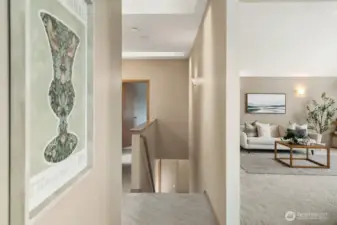 Main hall leading from living spaces to bedroom, full bath and primary beyond.