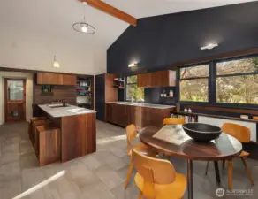 Sophisticated and understated: The kitchen is Henrybuily, marrying craft design and pragmatic innovation. Stone counter tops, rich wood cabinetry, and contrasting colors create warmth.