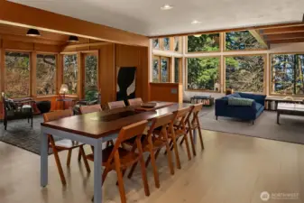 From the dining area, a sequence of rooms unfolds to substantial windows, inviting in natural light.