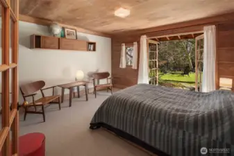 Second bedroom on the Main level. Warm, wood framed glass doors every room, to outside.
