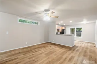 Open living space with comfortable layout connecting to the kitchen.