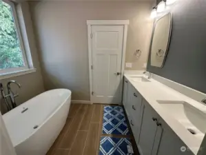 Primary bathroom with free standing soaking tub.