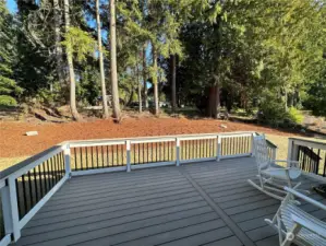 Large deck with steps into yard, overlooking golf course.
