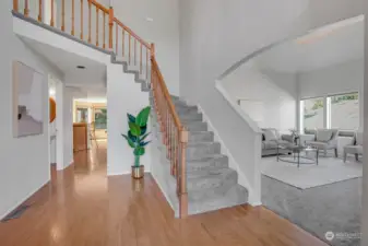 As you enter the home you are greeted by a grand two-story foyer and gleaming hardwood floors.