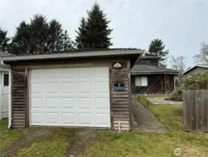 Detached garage has plenty of storage and workspace.