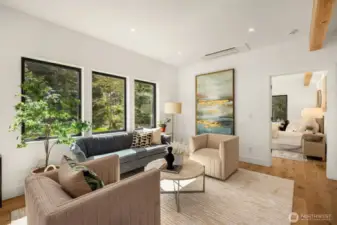 From the living area, you approach the primary suite - 10 ft ceilings and an abundance of natural light.