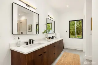 Primary bath with walnut double vanity, quartz counters, walk-in closet, shower and water closet with bidet.