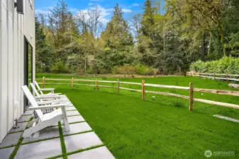 The home is sited on 1.03 acres and includes a protected wetland buffer ensuring privacy and natural beauty in perpetuity.