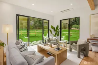Three sets of sliding doors brings nature into your the living space. Gorgeous engineered oak hardwoods lend to the coziness.