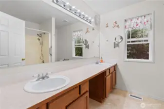 Primary ensuite bathroom with a double vanity.