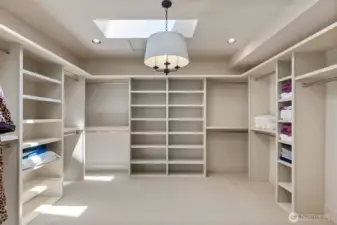 Spacious walk-in closet featuring ample storage and a convenient washer/dryer hookup.