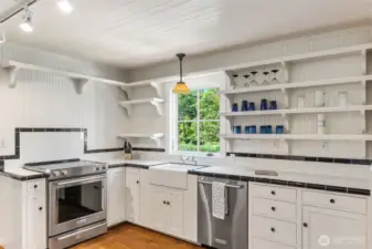 Second kitchen equipped with KitchenAid appliances and a stunning deep farmhouse sink.
