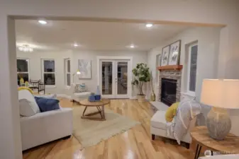 Looking from the library room into the living room with a nice gas fireplace.