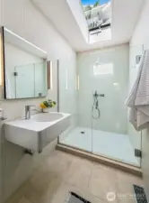 The 3/4 bathroom is ensuite to the office/guest bedroom. Skylights flood the space with light.