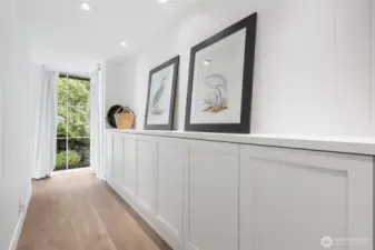 Thoughtful design includes built-in storage, gallery-style art walls, and corner windows that frame natural light.