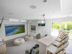 The family/media room is designed for cinema-quality viewing with a 134" framed UHD projection screen, Powerlite home theater projector, and an additional retractable screen. Origin Acoustics’ 7-speaker, dual-subwoofer system delivers rich, powerful sound.