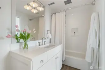 A private full bathroom serves the second bedroom, enhancing its suite-like feel.