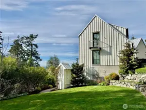 The home is fronted by a graceful lawn, with the second primary suite distinguished by its Juliette balcony overlooking the grounds.