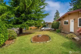 Large sunny front yard ready for all your gardening plans.  Check out the open fencing, nicely defining the front of property.