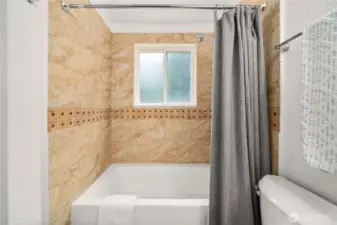 Timeless and elegant. Fully tiled shower surround and tub.