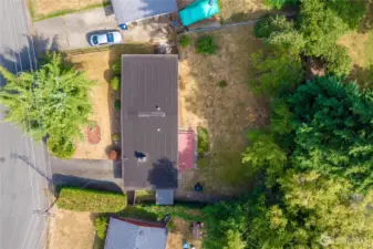 Full property view with torch down easy-clean roof, plentiful parking and another view of the gated backyard.