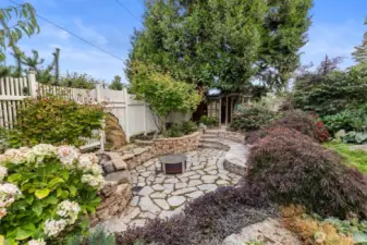 One amazing feature of the lush grounds is the sunken fire pit and stone seating. Cleverly incorporated in to the native plant species, this private hollow could seat over a dozen, with easy access to the kitchen area. Entirely private from the street and neighboring homes, you feel immersed in the mature natural setting.