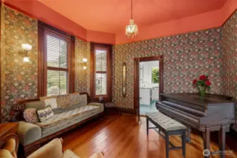 A view of the parlor and piano room. Rich golden Vertical Grain Fir floors adorn the entire first floor, milled from trees cut 140 years ago, they're more rich a beautiful than the day they were first laid.