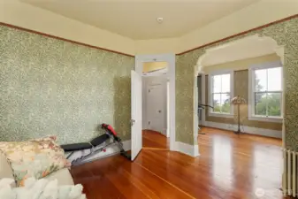 The main Bedroom just at the top of the stairsway. Spanning the width of the home and commanding a fantastic view of the surroundings, this space has VG Fir flooring and period appropriate fixtures and wall finishings, as does the entire home.