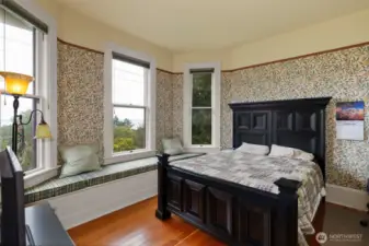 The second bedroom on the second floor features a beautiful view and lots of light. the golden fir floors and window seat again, set the room apart from modern homes.
