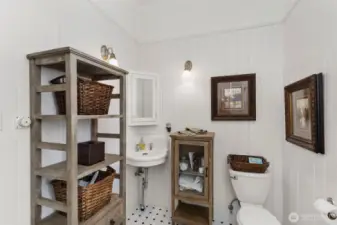 The upstairs bathroom and walk in shower with glass wall and crisp, clean tile work.
