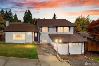 Evening front view with warm exterior lighting