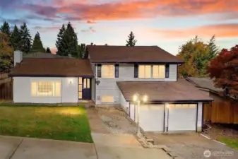 Evening front view with warm exterior lighting