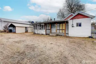 View of backyard and back porch. Carport can stay or be removed per buyers request.