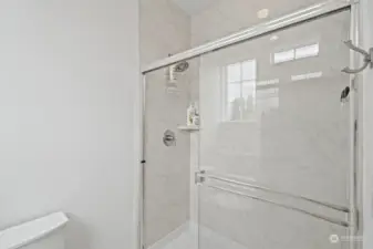 Separate commode room with low step shower.
