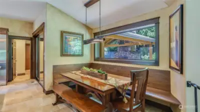 Custom walnut bench in kitchen nook was hand-made by a local craftsman. It’s super comfortable!