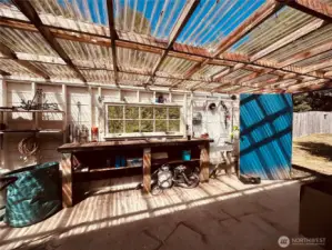 Green house located in back of shop/garage