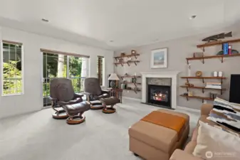 Light filled living room with cozy gas fireplace.