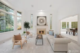 Elegant formal living room with tall ceilings, oversized windows, custom fireplace, and abundant natural light—perfect for refined entertaining or quiet evenings at home.