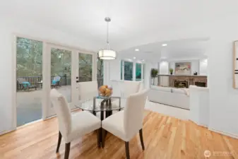 Casual dining nook features hardwood floors and a modern light fixture, offering direct access to the outdoor deck—perfect for morning coffee or easy indoor-outdoor entertaining.
