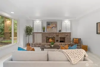 The family room anchored by a charming brick fireplace, built-in cabinetry, and large windows that bring in natural light and peaceful outdoor views—an ideal space to unwind.