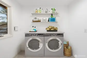 Upper-level laundry space with existing plumbing in place for a future washer and dryer, offering flexibility for customization. Image has been virtually staged to illustrate potential layout and use.