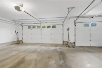 Large 3-car garage with two EV stations and a water spigot with hot and cold water to wash your cars.