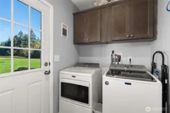Laundry room with access to backyard.