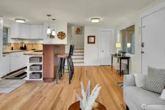 Main living space w/kitchen and stairs to bedrooms and bath