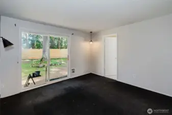 primary bedroom with entry to bathroom and exit to backyard