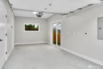 Finished garage with sliding door to fenced side yard