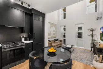 Experience seamless flow in this open-concept space, where modern black cabinetry meets inviting living areas, perfect for relaxing and entertaining.