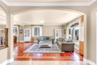 Curved archways, engineered hardwood and travertine tile floors